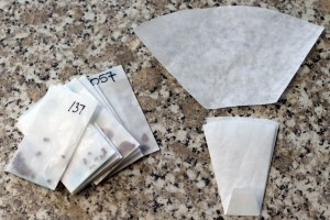 Packets of seeds and filter paper, before and after folding.